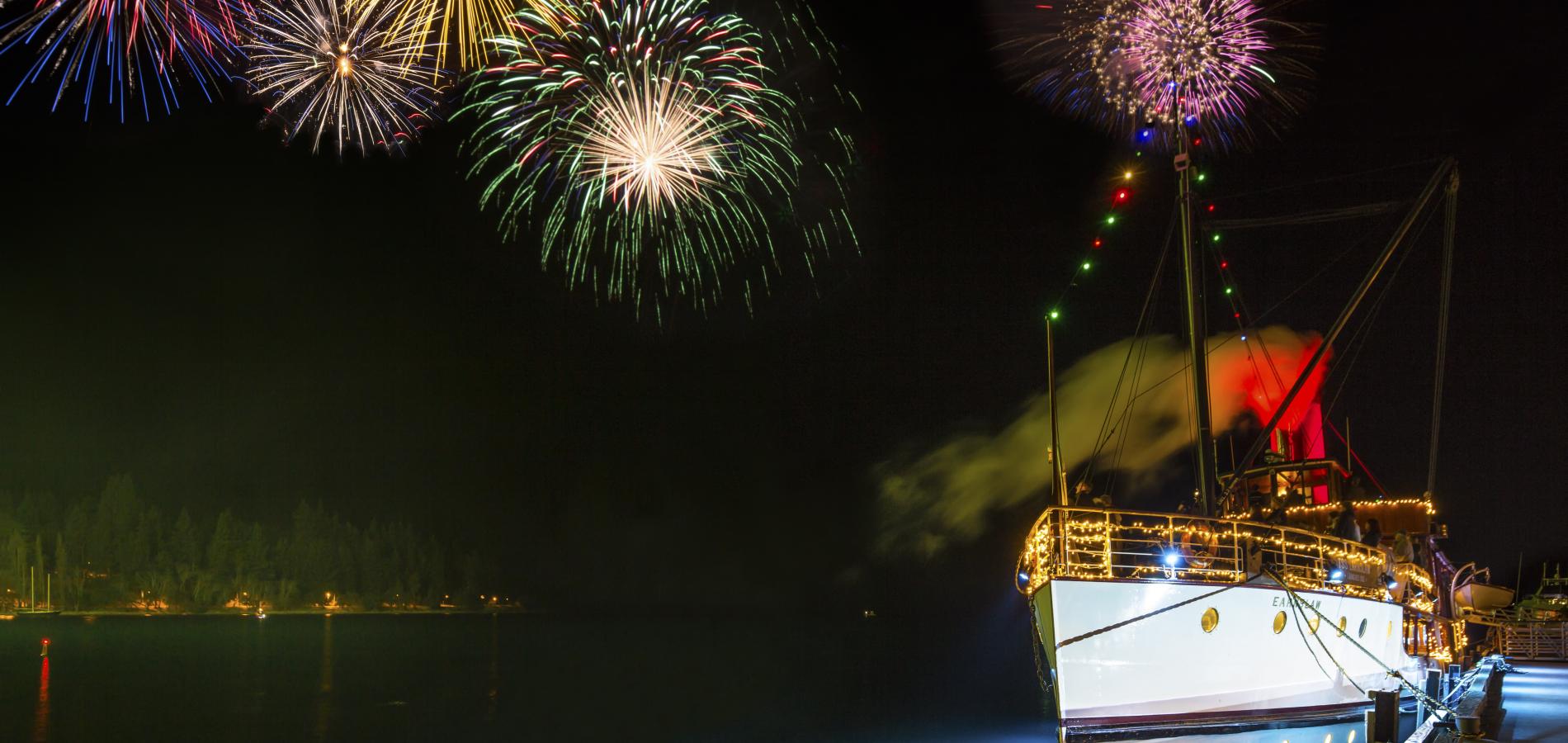 The Real Journeys Queenstown Winter Festival - fireworks over Lake Wakatipu with the historic steamer TSS Earnslaw in the foreground